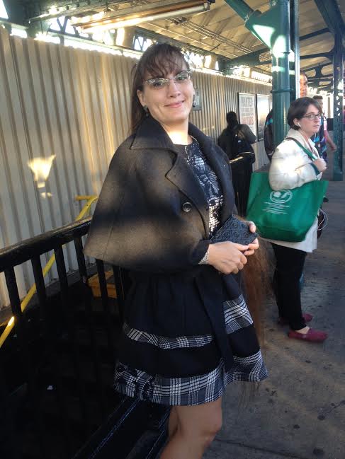 marie in swing coat on rail platform