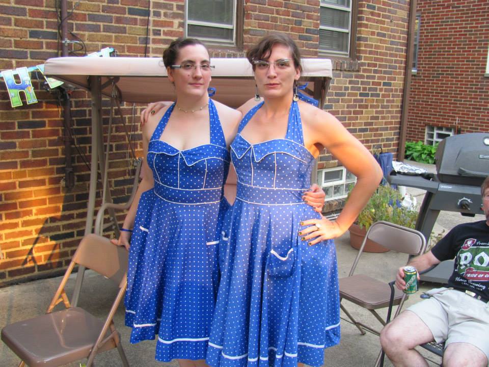two women in identical blue dresses