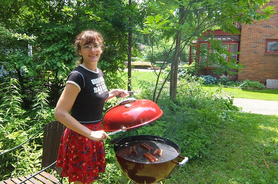 Woman at barbecue grill