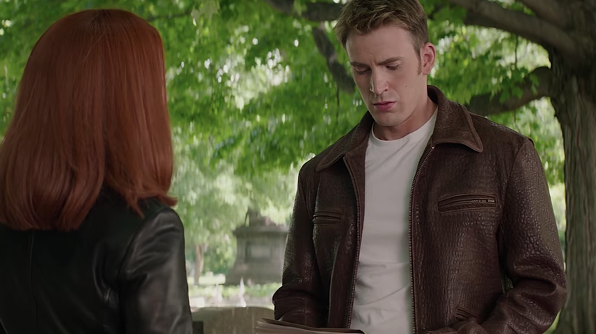screen capture of captain america standing in front of a distinctive monument in a cemetery setting