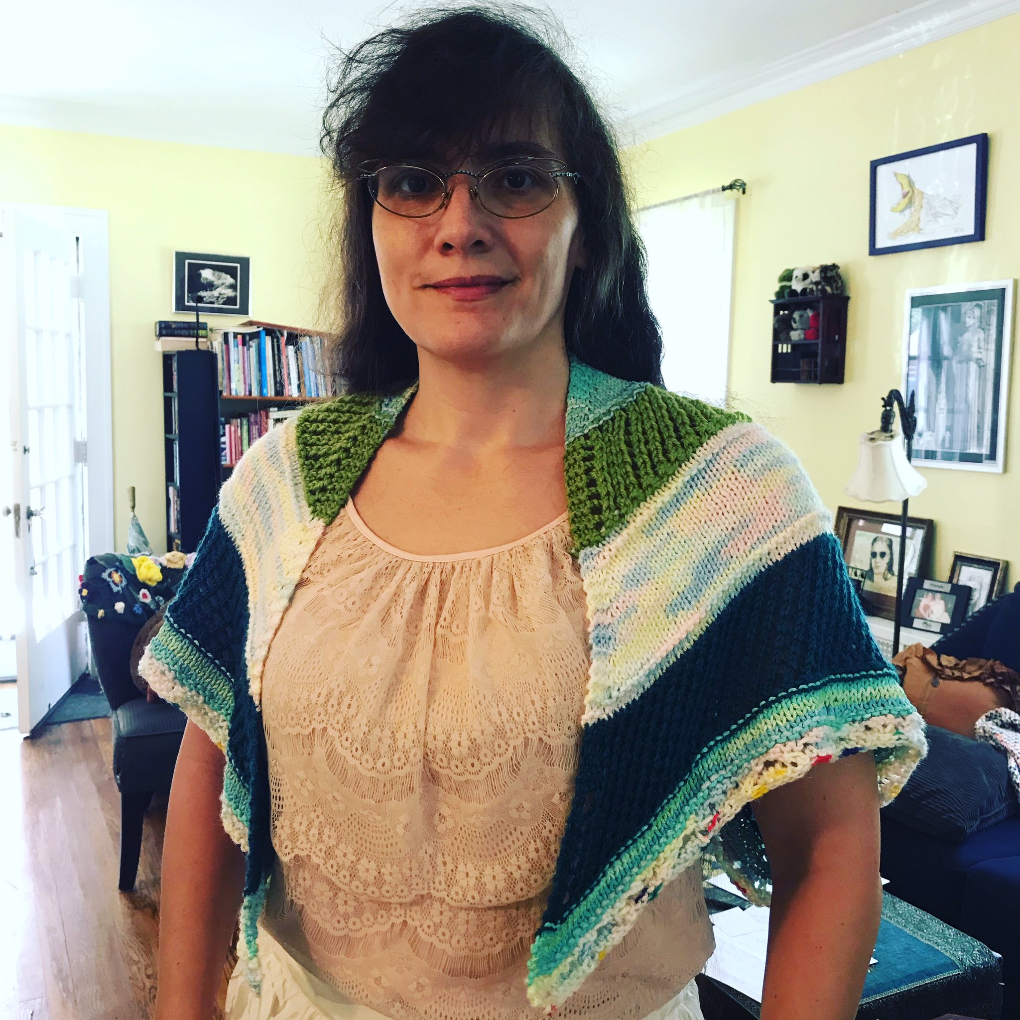 Marie in her living room wearing a blue and white knit shawl