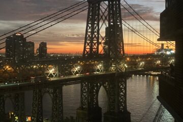 Sunrise through the Williamsburg Bridge over the East River