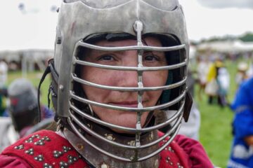 woman making a weird face in a grilled helmet