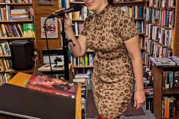 Marie in a slinky leopard-print dress with cat ears