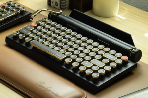 A small, almost flat keyboard that has keys like an old manual typewriter and a roll-bar on top.